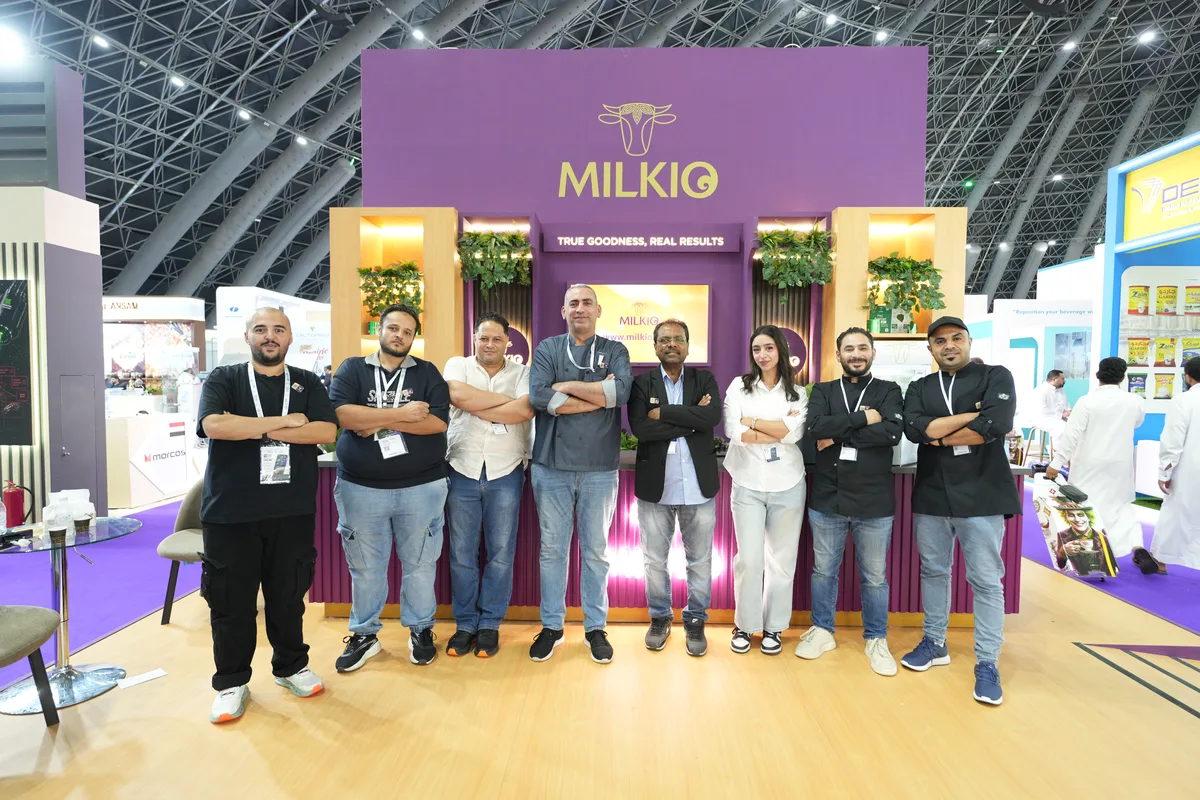The ZAAC team standing together in front of the Milkio booth